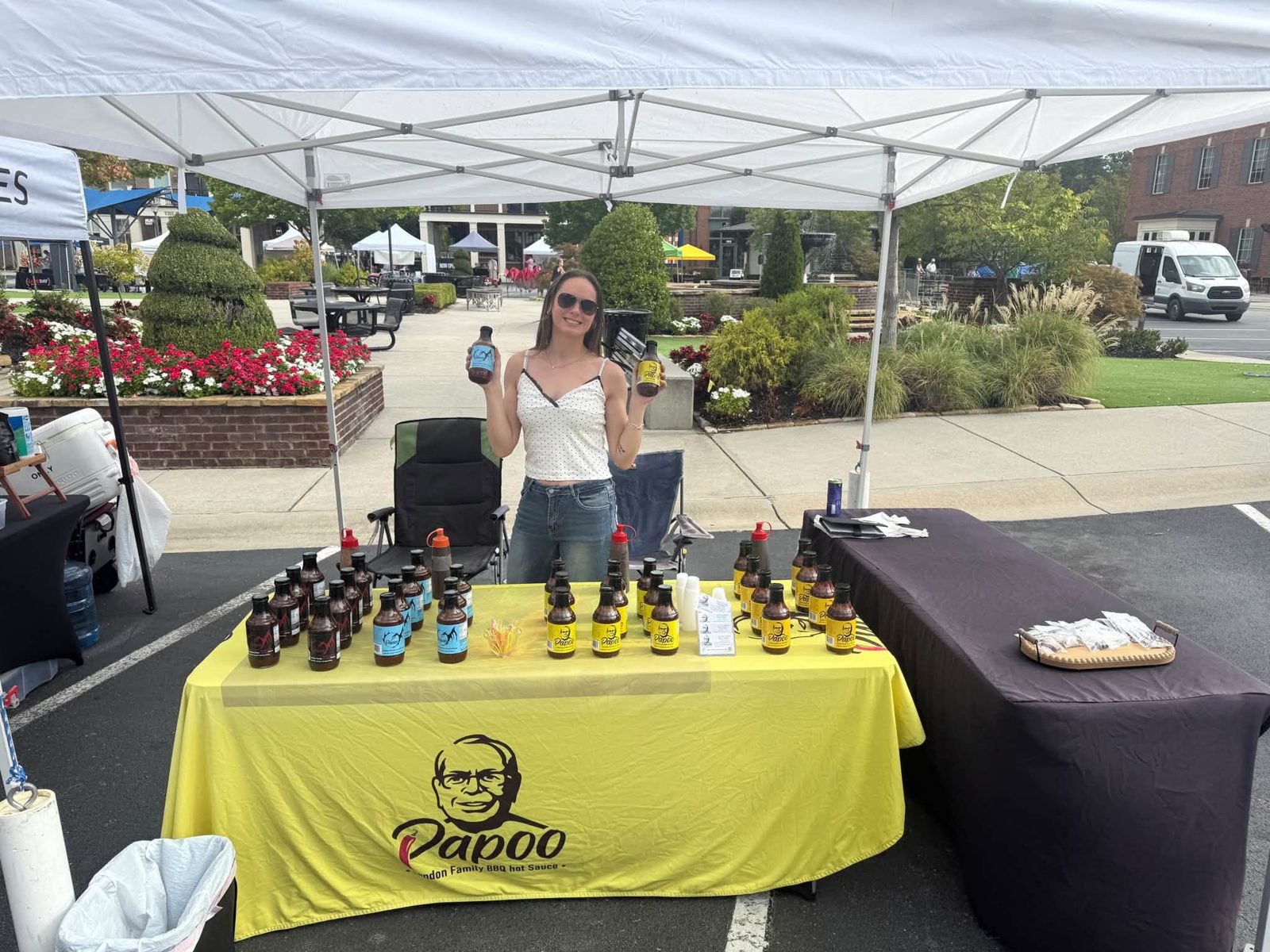 Papoo's BBQ Sauce booth with the yellow tablecloth
