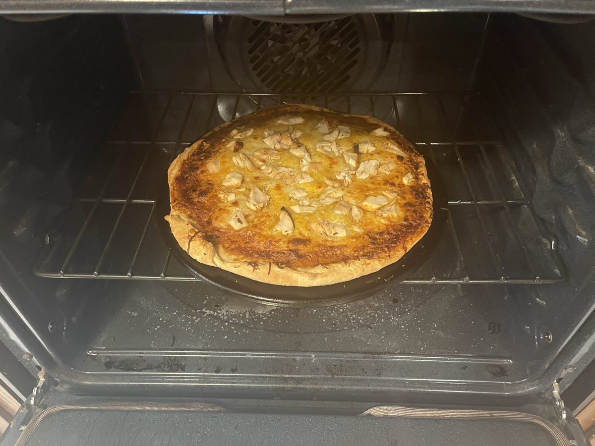 BBQ chicken pizza baking in the oven