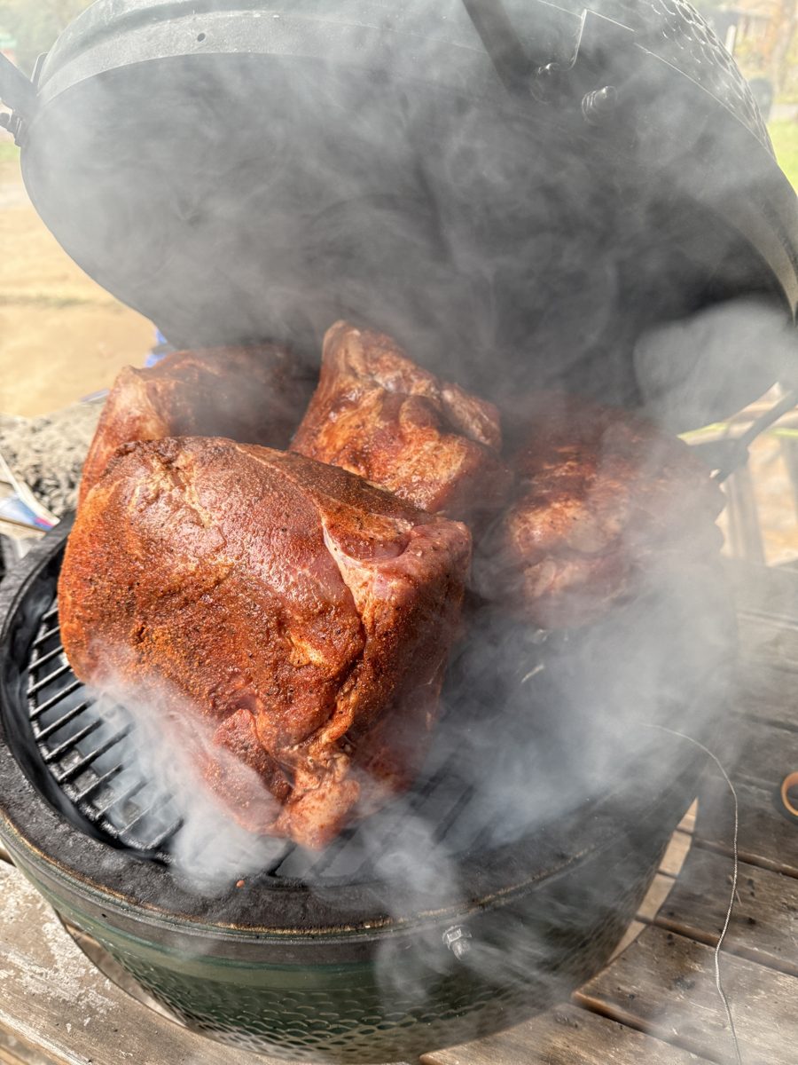 Pork butts with rub in a smoking grill